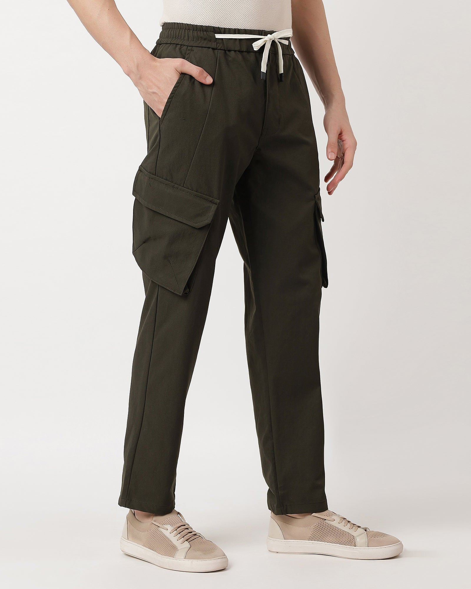 Person wearing a beige sweater and comfortable olive green cargo pants 